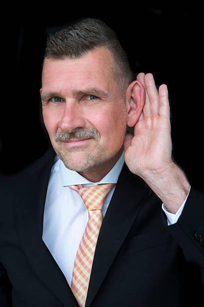 istock businessman with hand at his ear 490099918