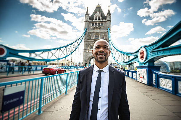 istock Business man walking at tower bridge in London 490100640