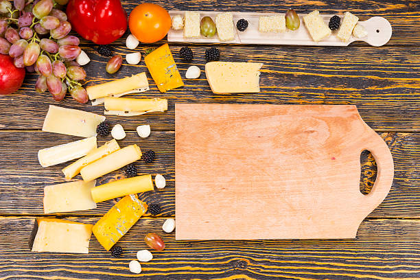 istock Wooden Board Surrounded by Cheese and Fresh Fruit 490103580