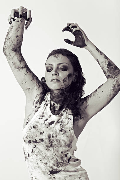 istock woman with face and body covered in mud 490104064