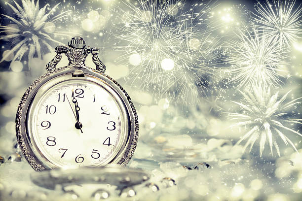 istock Old clock with fireworks and holiday lights 490104960
