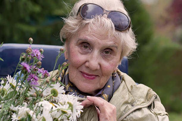 istock Senior Female With Flowers 490106148