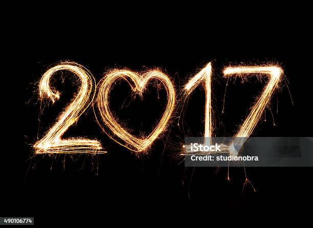 2017 Word Written With Sparkle Firework On Black Background Stock Photo - Download Image Now