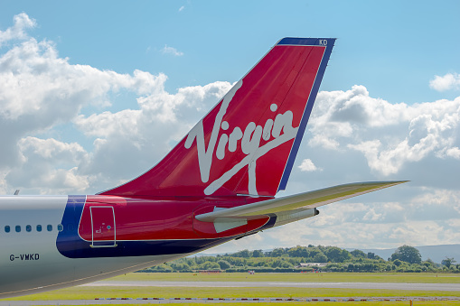 Manchester, United Kingdom - August 07, 2015: Virgin Atlantic Airways Airbus A340 tail livery at Manchester Airport.