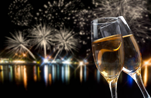 Celebrating New Year with champagne and fireworks stock photo