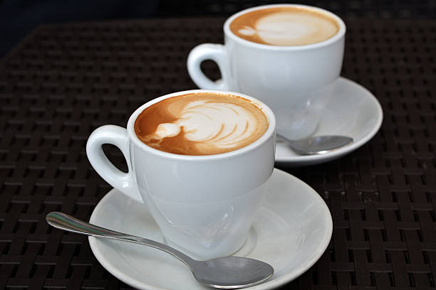 istock Delicious foamy cappuccino on the black background 490107738