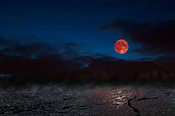 Red full moon in red color also called bloodmoon on the background frozen sea.