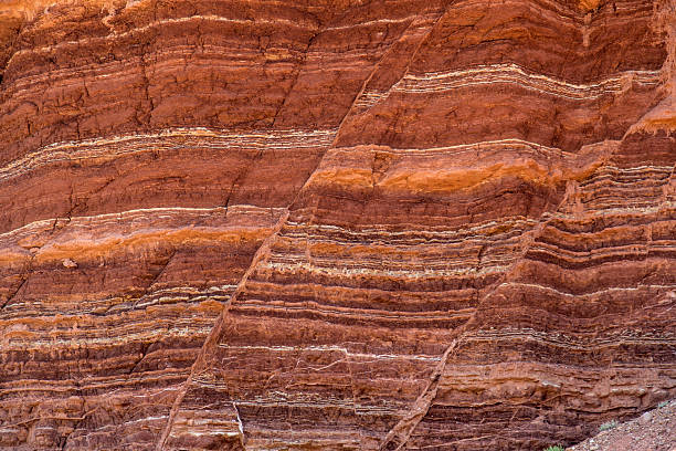 Stone Formation Showing Fault Lines Fault lines and colorful layers in standstone also useful as a background or texture. geology stock pictures, royalty-free photos & images