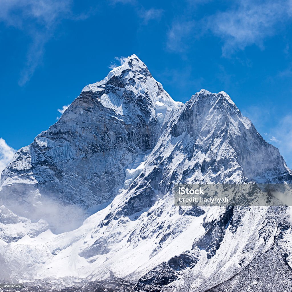 Mount Ama Dablam - Himalaya Range, Nepal Ama Dablam is a mountain in the Himalaya range of eastern Nepal. The main peak is 6,812  metres (22,349 ft), the lower western peak is 5,563 metres (18,251 ft). Ama Dablam means  "Mother's neclace"; the long ridges on each side like the arms of a mother (ama) protecting  her child, and the hanging glacier thought of as the dablam, the traditional double-pendant  containing pictures of the gods, worn by Sherpa women. For several days, Ama Dablam dominates  the eastern sky for anyone trekking to Mount Everest basecamp.http://bem.2be.pl/IS/nepal_380.jpg Himalayas Stock Photo