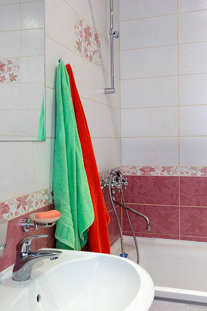 istock Multicolored towels over the sink in bathroom 490126840