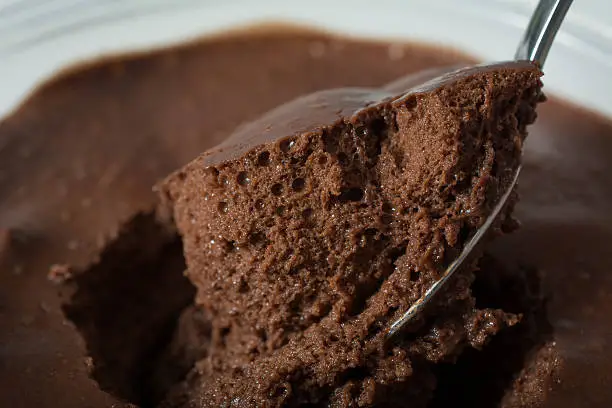 Close up Very dark chocolate mousse on a spoon ready to eat