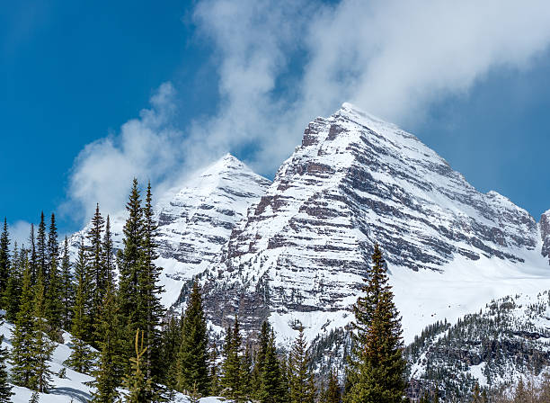istock Rocky mountain peaks with snow and clouds 490127342