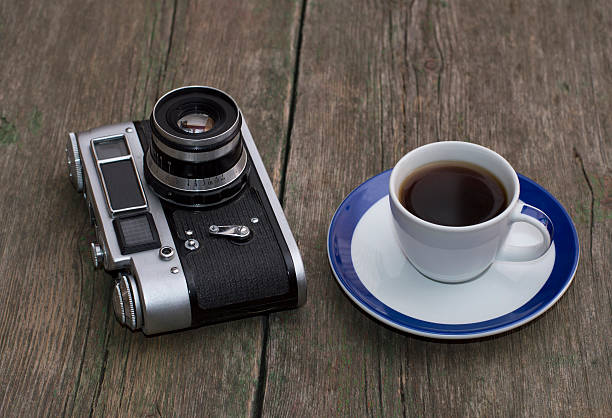 istock old camera and cup of coffee on a wooden table 490128290