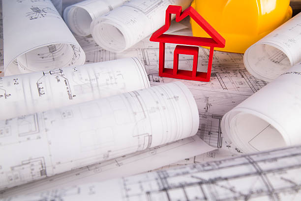 istock Architectural project and Yellow helmet and house model 490129020