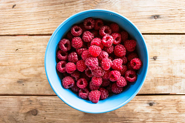 istock Raspberries on a wooden background 490129246