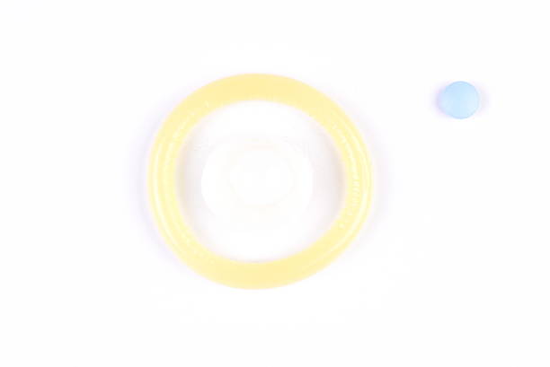 istock Close-up Condom and a blue pill 490129692