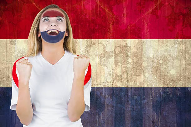 istock Excited netherlands fan in face paint cheering 490129825