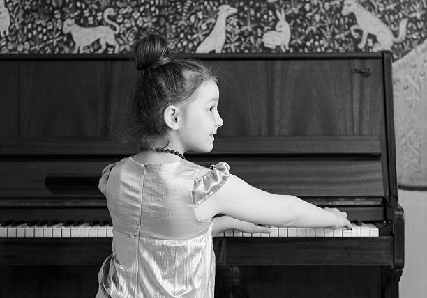 istock Little Girl Playing Piano 490130689