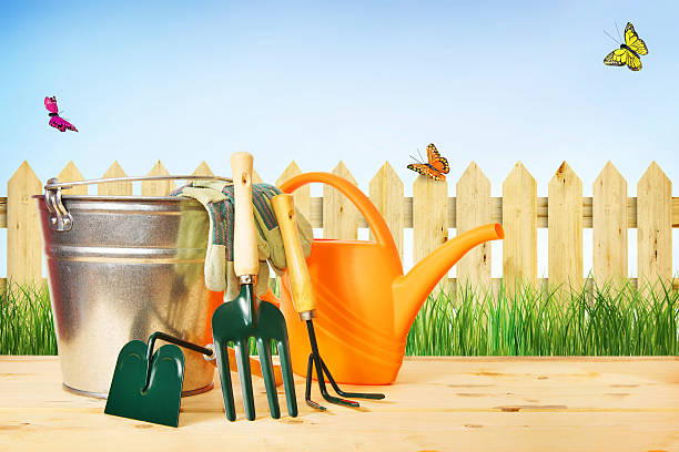 istock Gardening composition with tools against green grass and wooden fence 490131067