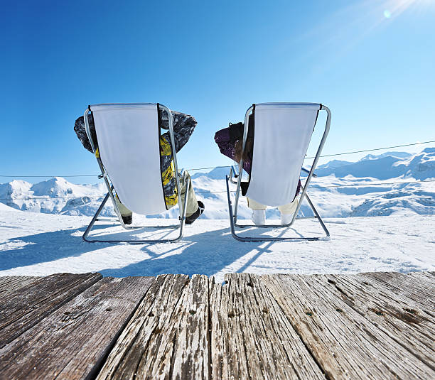 Apres ski at mountains Couple at mountains in winter, Val-d'Isere, Alps, France apres ski stock pictures, royalty-free photos & images