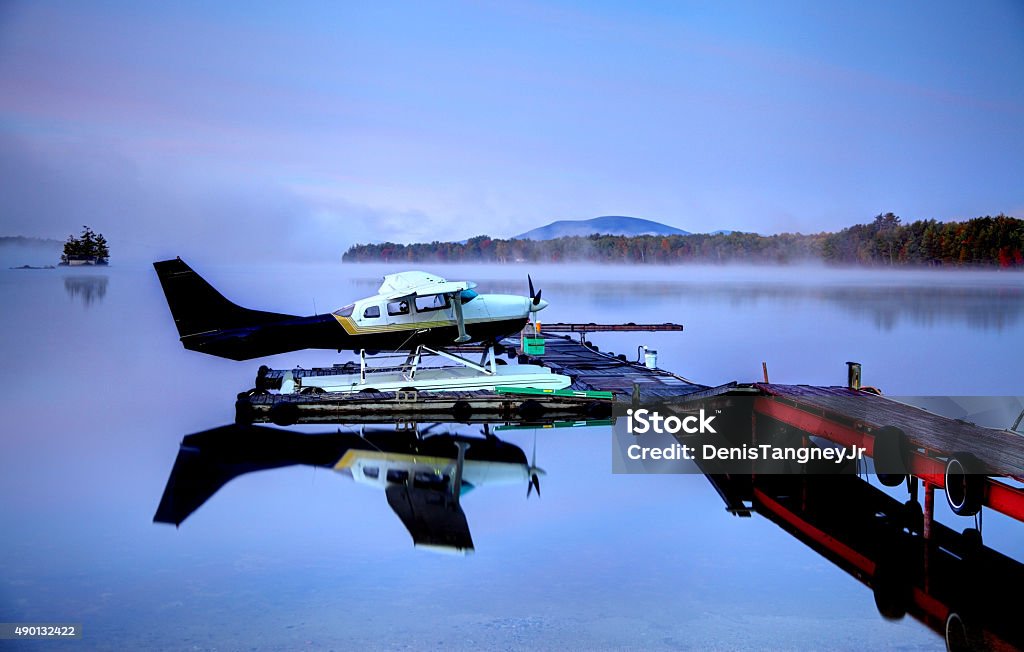 Seaplane on a calm lake in Maine Seaplane on a calm lake in Maine during autumn Autumn Stock Photo