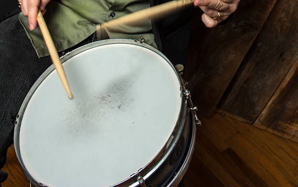 istock Drummer Playing A Musical Percussive Snare Drum 490132729
