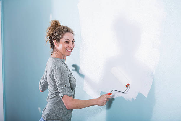istock Woman painting wall 490132805