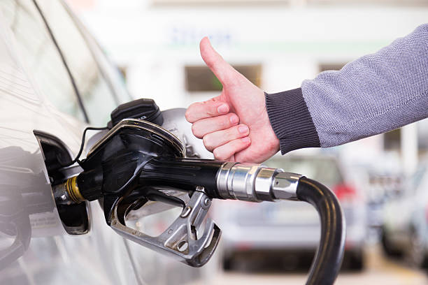 Petrol being pumped into a motor vehicle car. stock photo
