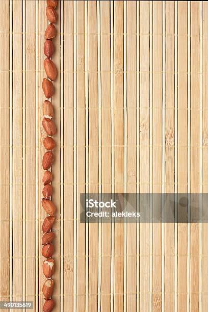 Cases A Band Of Peanut Lying On Bamboo Mat Stock Photo - Download Image Now - Backgrounds, Bamboo - Material, Brown