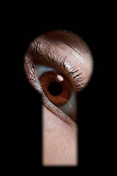 istock male Eye peep through the keyhole 490136021