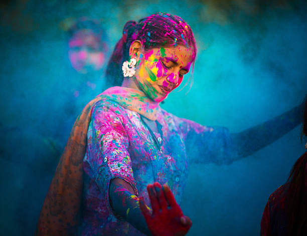Holi Festival in India Young woman dancing around blue powder while celebrating the Indian Holi Day rajasthan photos stock pictures, royalty-free photos & images