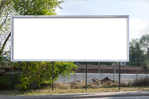 Empty billboard on the highway roadside with sky and nature background, billboard with clipping path