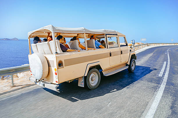 Antalya, Turkey - September 9, 2015: 4x4 safari jeep with some tourist people on road for trip around Kas, Fethiye against nature background 