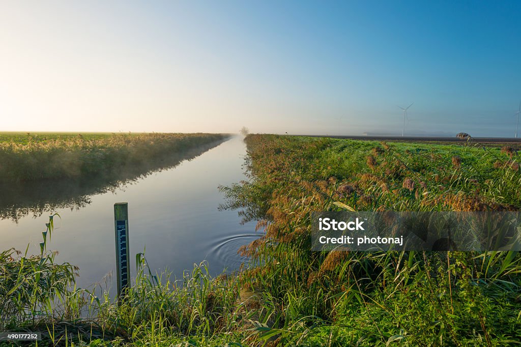 Canal through a sunny hazy landscape in autumn 2015 Stock Photo