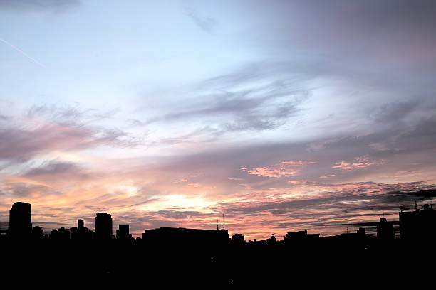 istock Pink cloudy sky with city silhouette 490177634