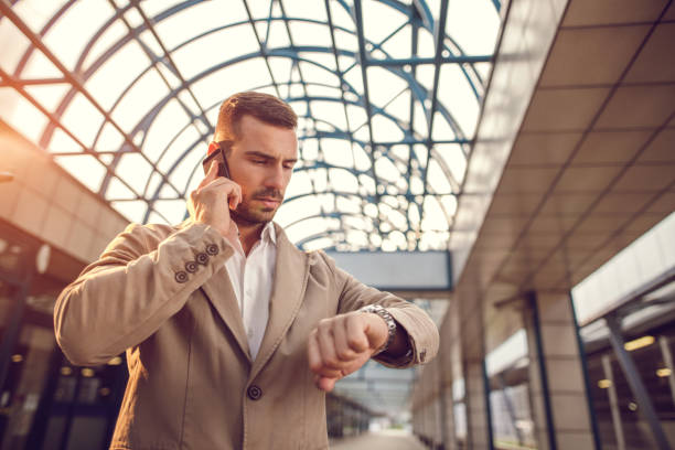 istock Young businessman on the phone checking the time. 490178396