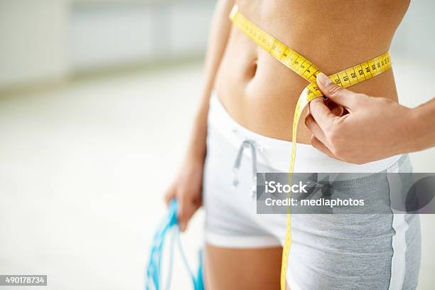 Losing Weight Stock Photo - Download Image Now - Tape Measure, Women, Dieting