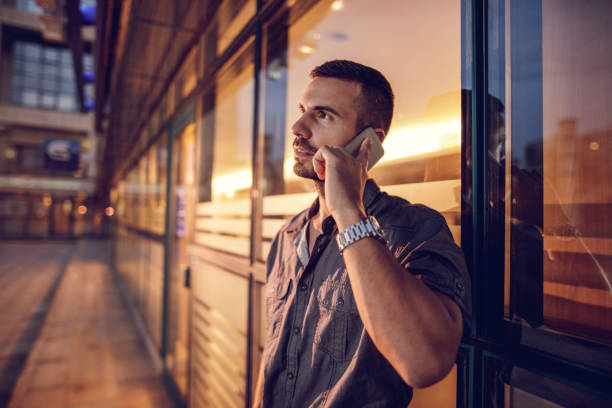 istock Young businessman talking on cell phone outdoors and looking away. 490179858