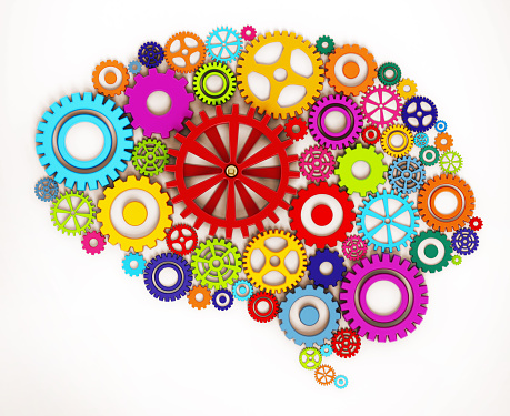 3D rendering of gears that are placed together in the shape of the human brain.  The gear in the center features multiple spokes and is red in color.  The composition of red, blue, green, yellow and orange gears is set against a white background.