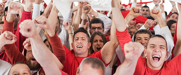 istock Group of ecstatic sport fans cheering and looking at camera. 490184350