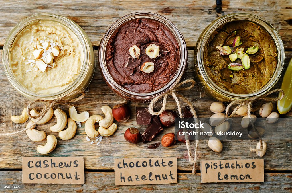 list toasted nut butters, pistachio, hazelnut and cashew list toasted nut butters, pistachio, hazelnut and cashew. toning. selective focus 2015 Stock Photo