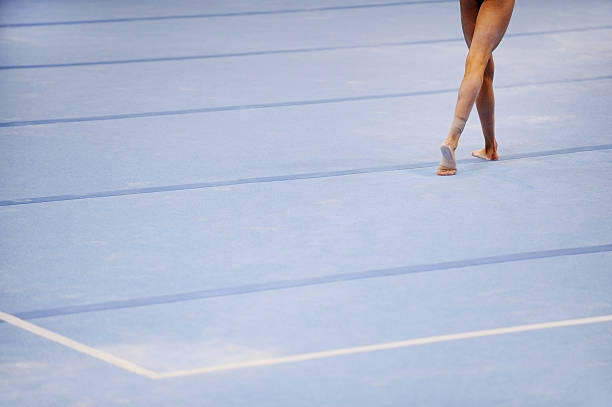 Feet on gymnastics floor stock photo