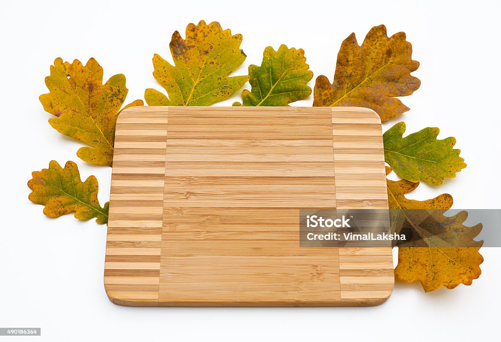 Autumn oak leaves and kitchen wooden cutting board top view 2015 Stock Photo