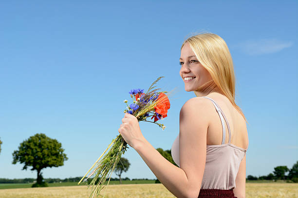 istock Beautiful young blonde woman standing in corn field 490187292