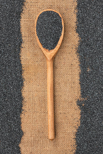 istock Wooden spoon with poppy seeds lying on sackcloth 490199949