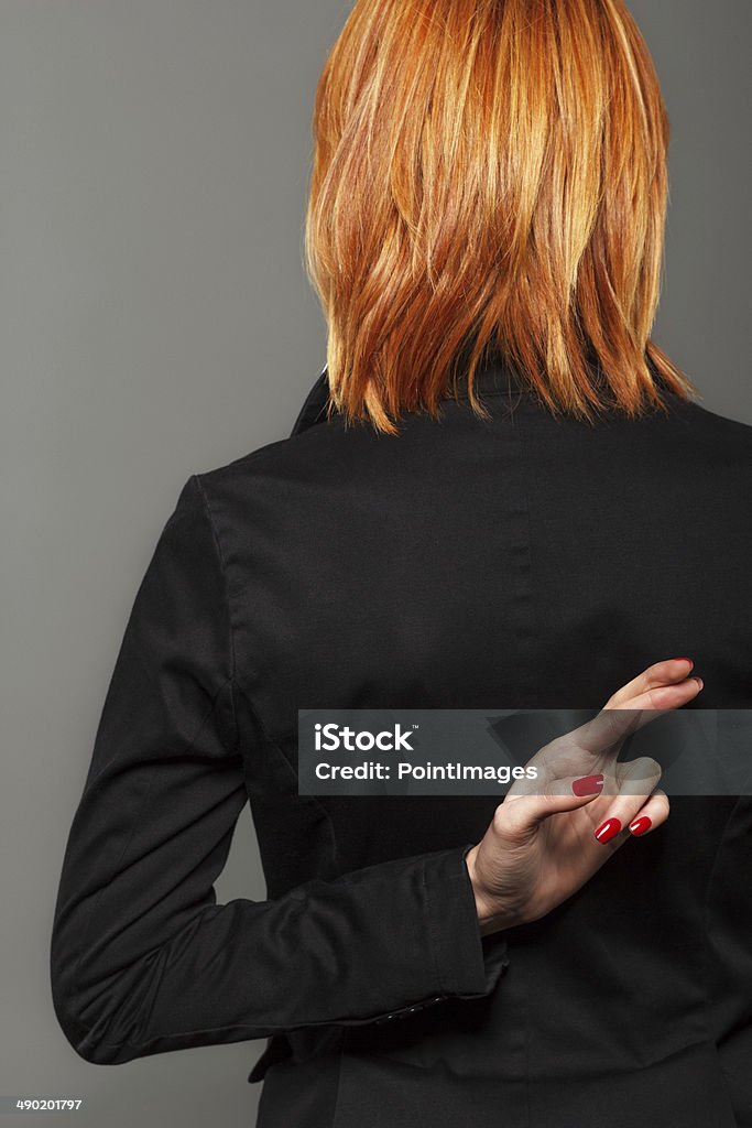 Fingers crossed Fingers crossed behind back. Dishonesty Stock Photo