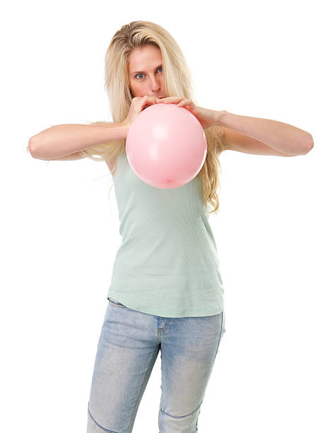 istock Young blond woman inflating balloon 490202895