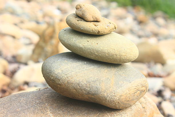 istock Stones pyramid near small river symbolizing zen 490205445