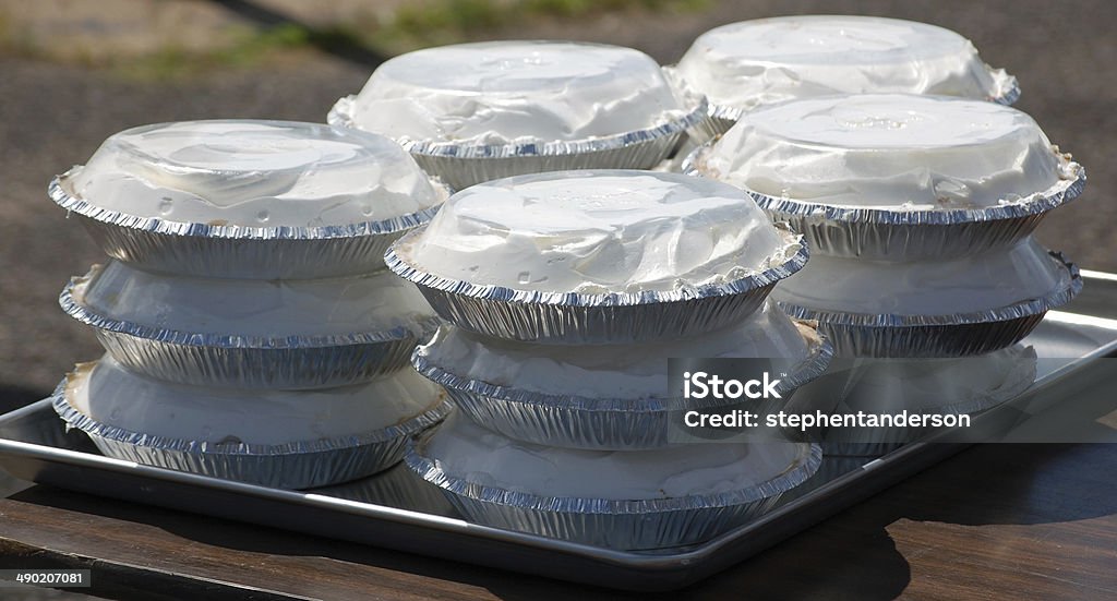 Pies for a pie eating contest Pies with whipped cream are stacked on a tray in preparation for a pie eating contest. Table Stock Photo