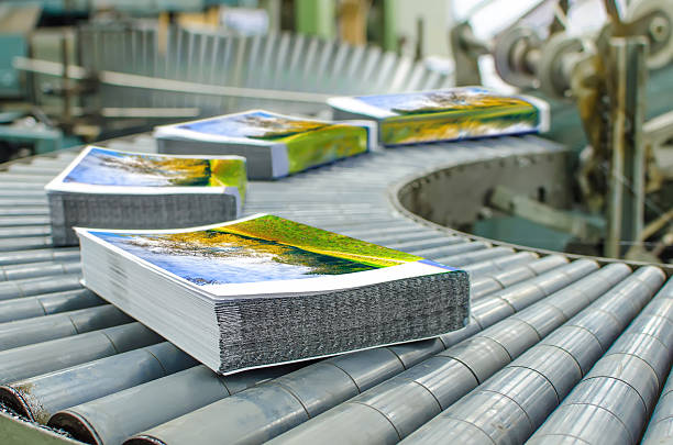 Book, magazine, catalog production line into press plant house. Binding cover and assembling with the spline. tangled photos stock pictures, royalty-free photos & images